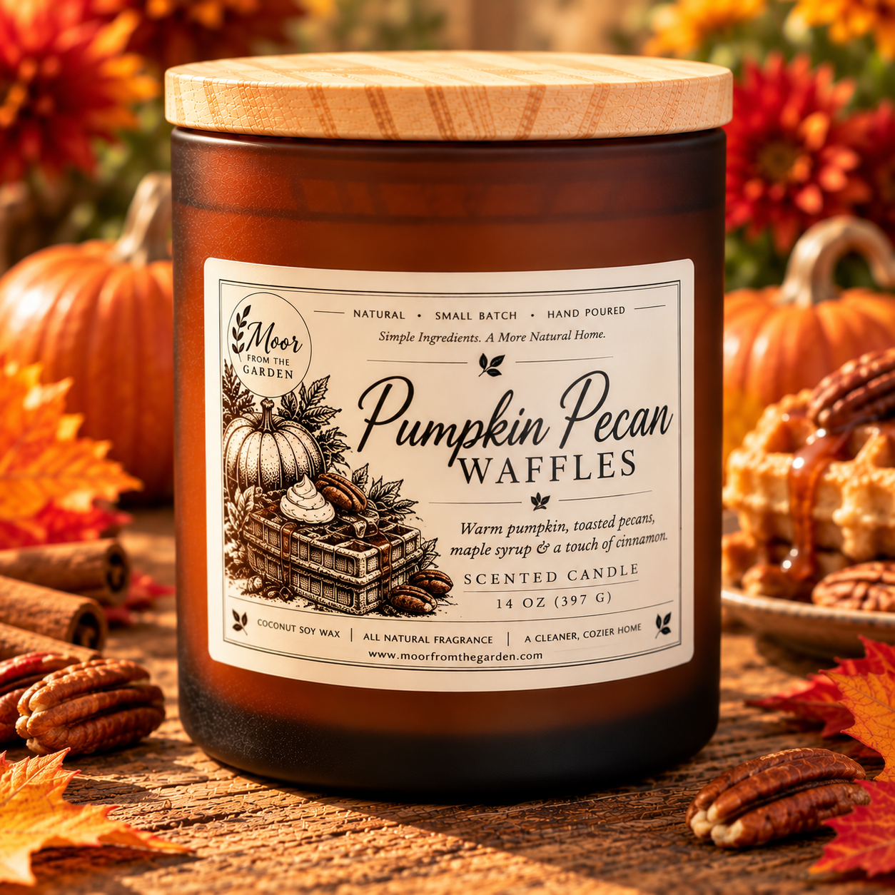Pumpkin Pecan Waffles candle beside waffles topped with pecans, with pumpkins and fall leaves